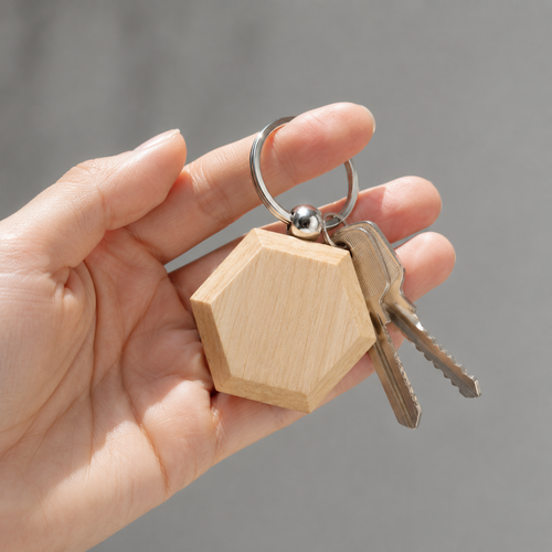 Minimalist design keychain in natural wood.