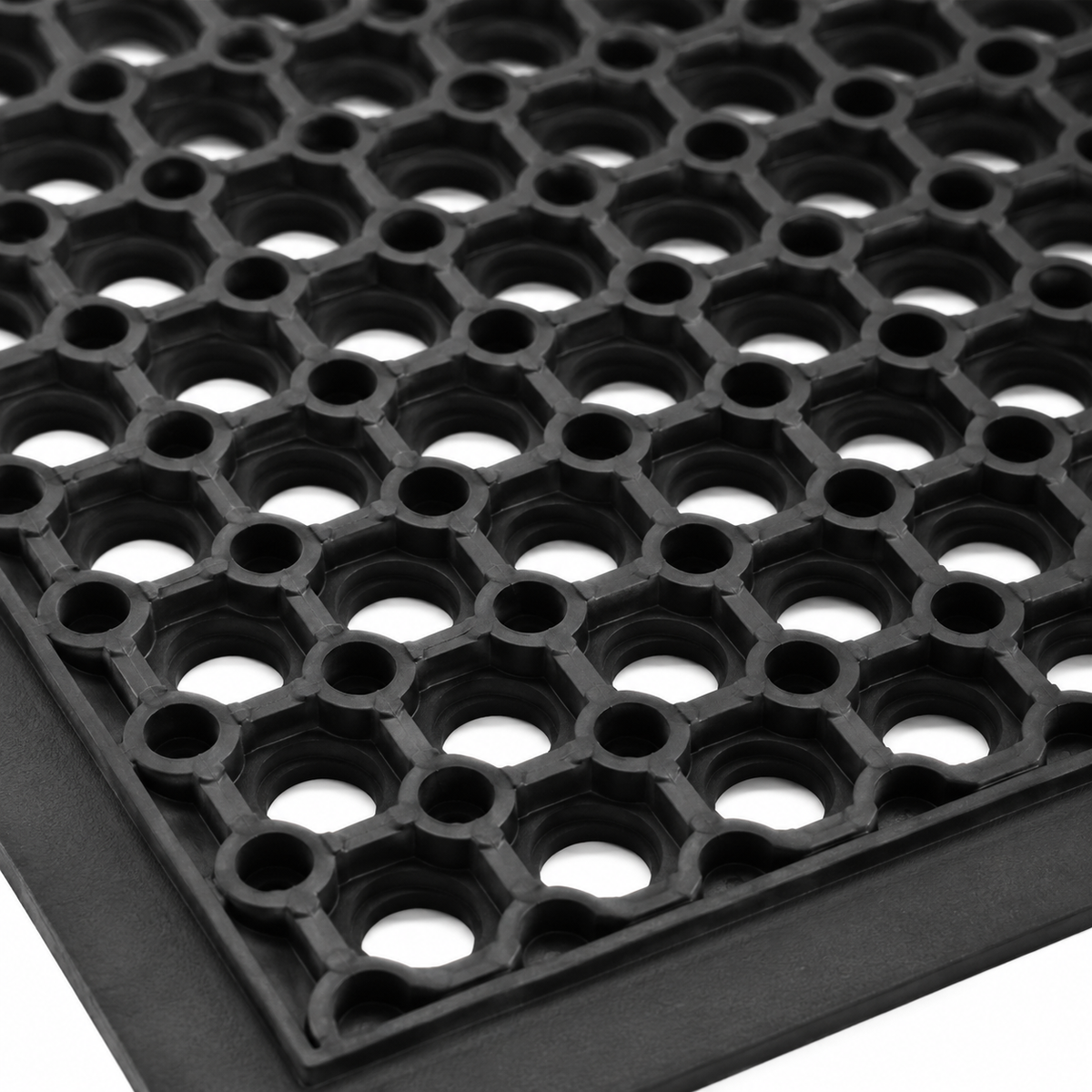 Durable rubber floor mat with drainage holes.