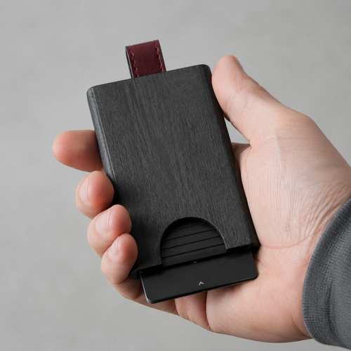 Side angle of sleek wooden card holder in black