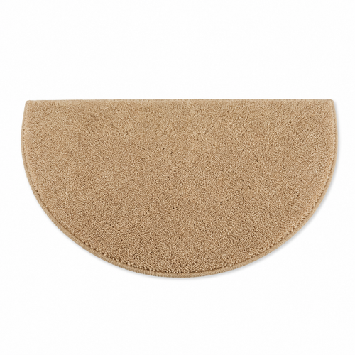 Beige half circle bath mat on white background.