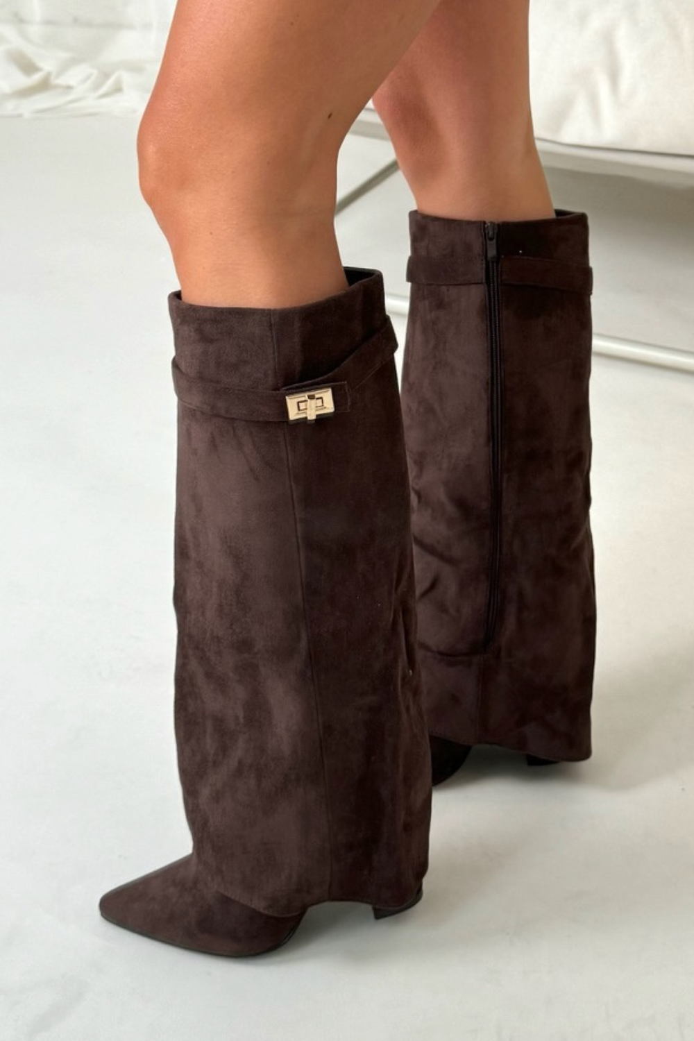 Close-up of block heel and premium materials on women's knee-high boots, emphasizing comfort and durability.