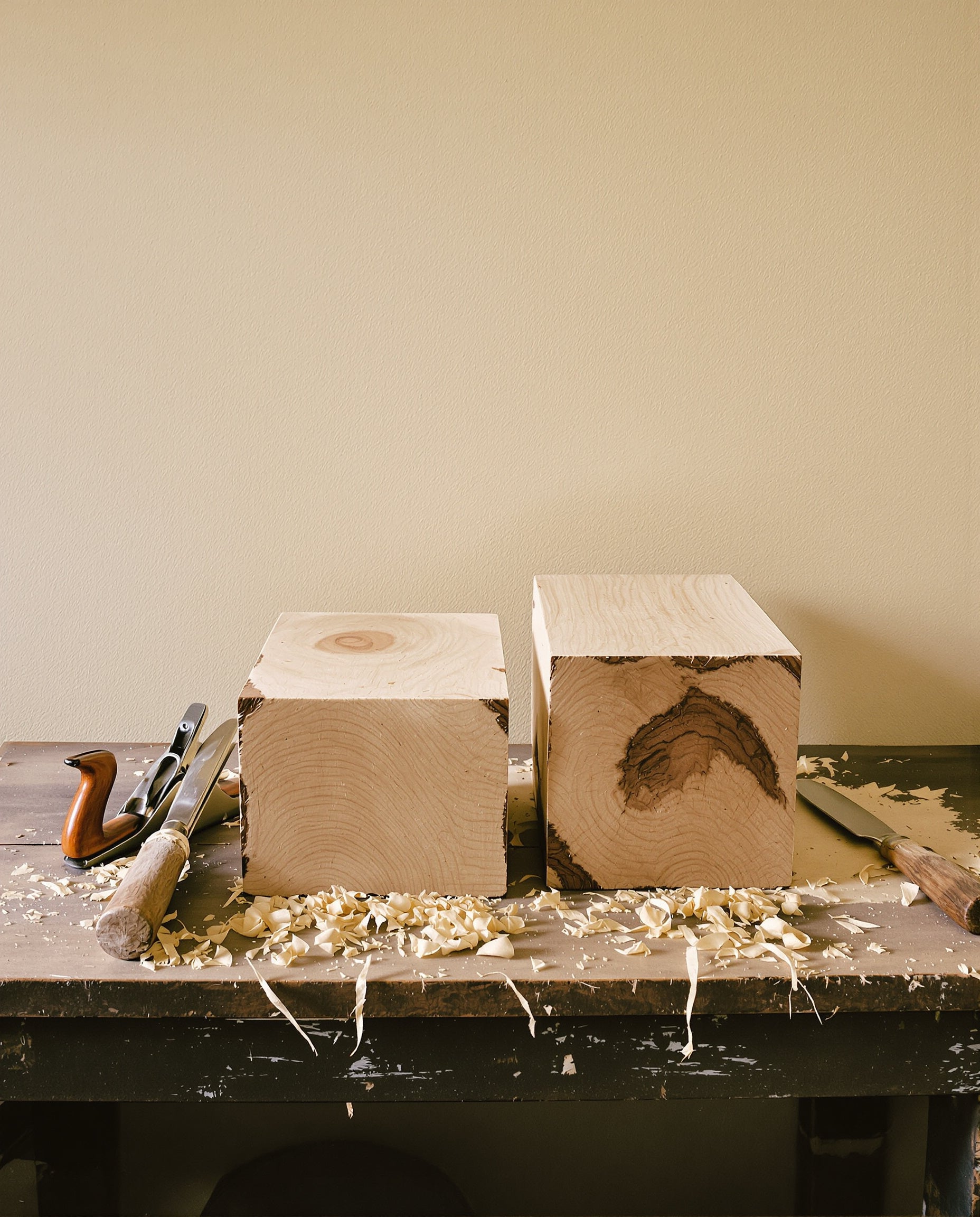 Raw lumber and woodworking tools — the material behind our blocks