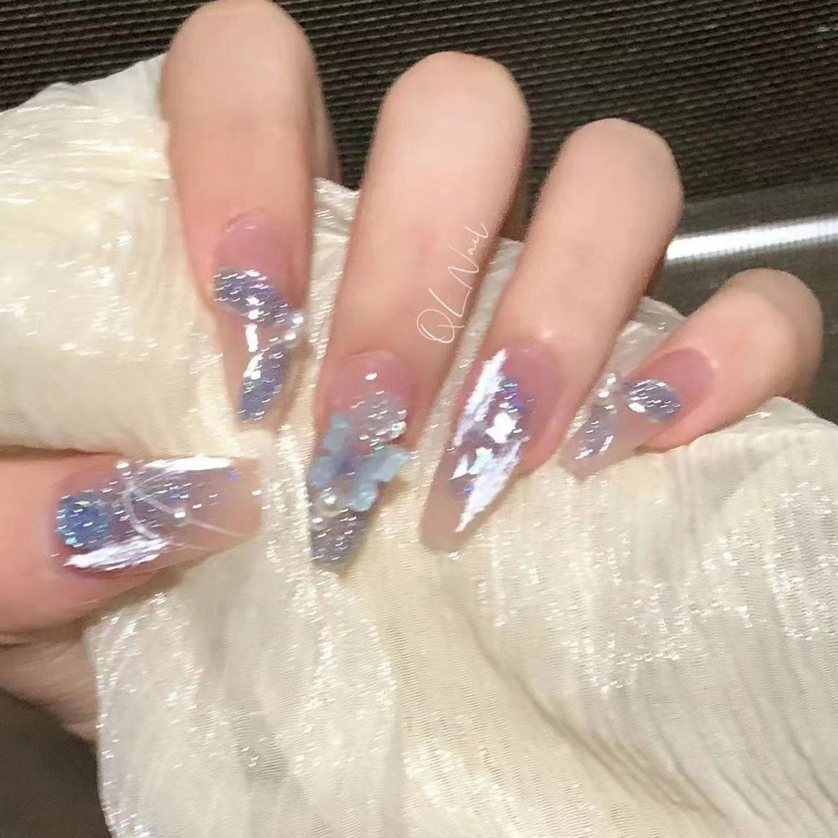 Artistic 3D nail extensions with glitter accents